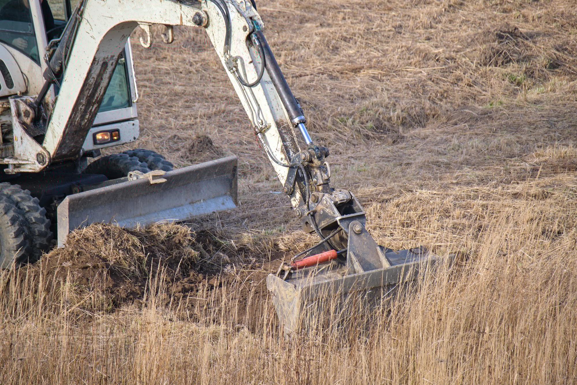 Earth moving tractor preparing place for future house foundation