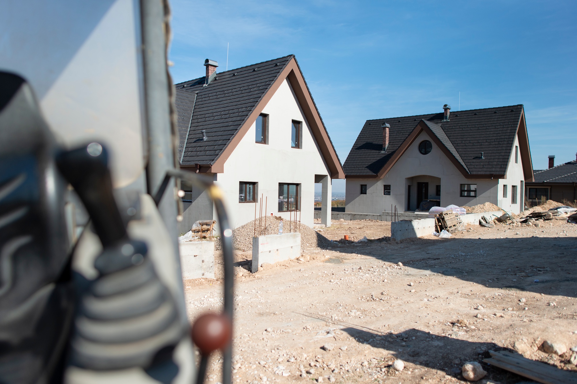 Excavator and new built houses