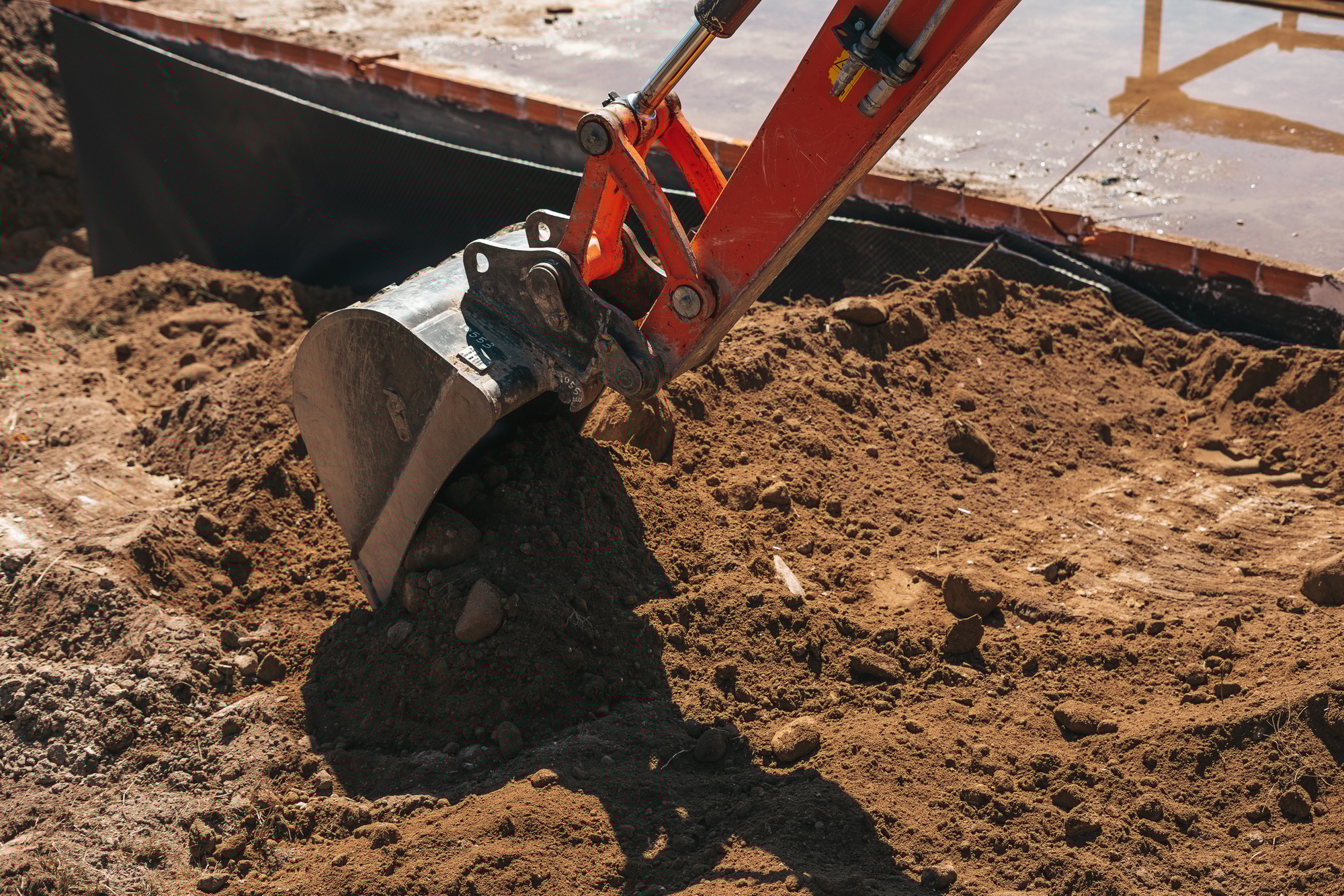 Excavator shovel digging on dirt