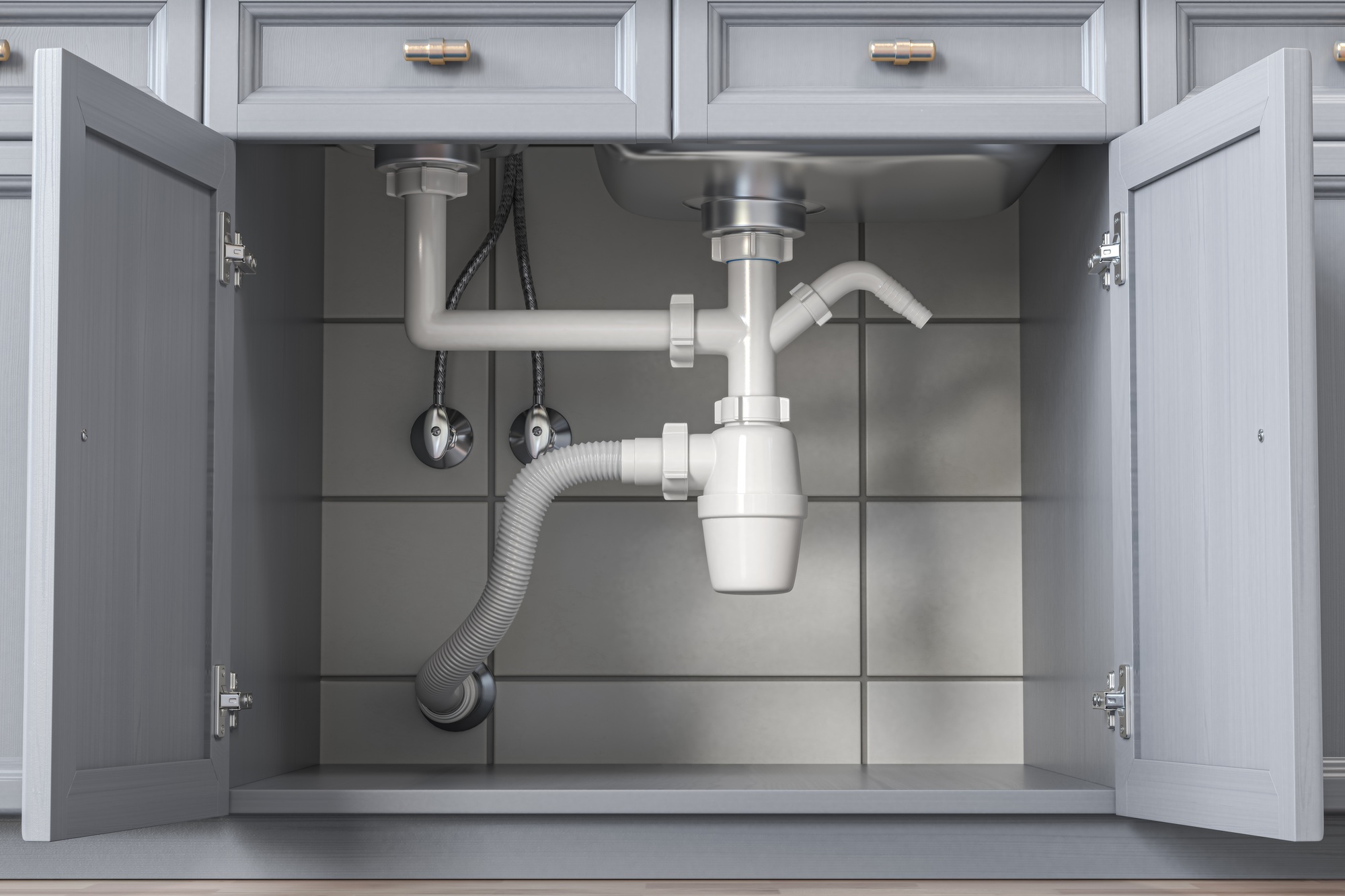 Siphon and pipes under the sink in the kitchen.